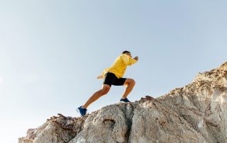 man climbing a mountain | HR Business Consultant