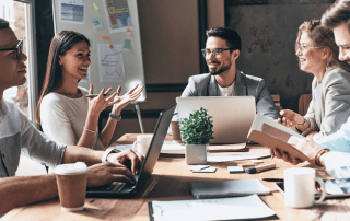 A team at a desk working | Featured image for Jobkeeper blog.