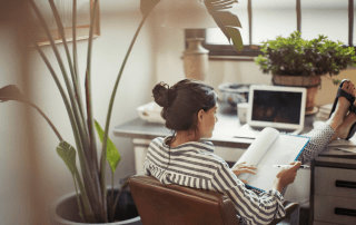 Woman with her feet up on her desk | Featured image for Working from Home Blog.