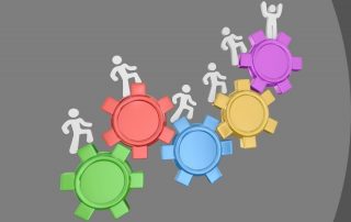 Photo of 5 gears each of which is a different colour and has figures climbing up them | featured image for Award Increase Blog for Bramwell Partners.