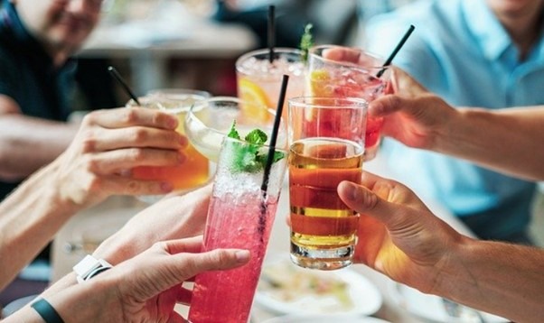 Toasting with cocktails | Featured image for the Alcohol in the Workplace blog from Bramwell Partners.