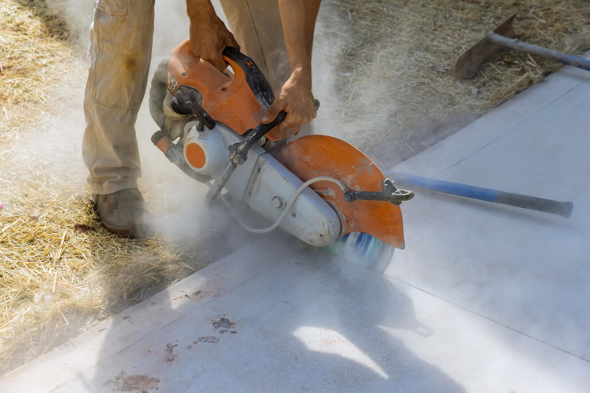 Concrete being cut with a saw | Featured Image for the Silica Dust Management Blog by Bramwell Partners.