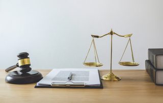 Scales, books and a clipboard on a desk | Featured image for the Fair Work Legislation Amendment – ‘Closing Loopholes’ Amendments blog by Bramwell Partners.