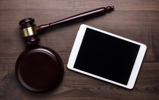 A judge's gavel next to a tablet | Featured image for the Fair Work Legislation Amendment – ‘Closing Loopholes’ Edition 2 blog by Bramwell Partners.