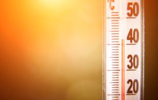 A thermometer showing a high temperature | Featured image for the Summer Work Safety blog from Bramwell Partners.